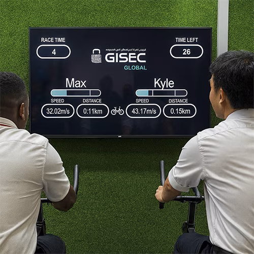 Guests racing on interactive bike game at corporate event in Dubai