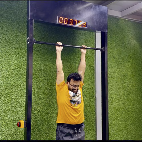 Viral 100-Second Hanging Challenge arcade machine rental for corporate events in Dubai, featuring a digital timer and participants testing their grip strength.