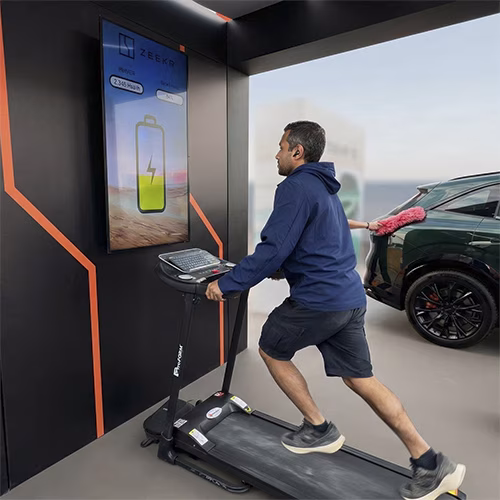 Interactive Treadmill Activation in Dubai: Participants generating human power to recharge EV cars