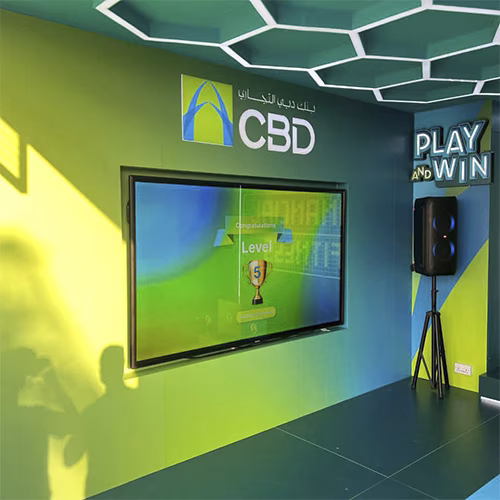 Interactive multi-level touch screen game rental at Dubai 30x30 event, showing guests engaged in a gamified fitness and financial literacy challenge.