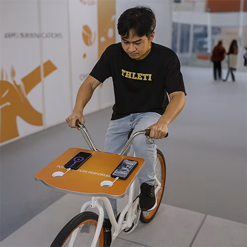 Guests competing to recharge their devices at a Recharge Station Challenge event, with branded stations and high-energy fun.