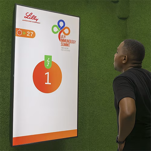 Participants enjoying the Squat Game Challenge at a corporate event in Dubai, engaging in fitness and team-building through real-time interactive squat tracking.